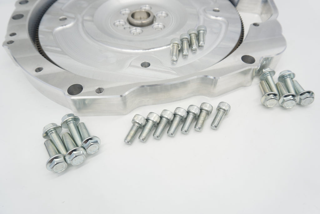 Close-up of LS to Jaguar 8HP billet flex plate installed in the adapter plate with flywheel bolts
