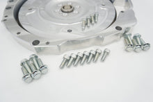 Load image into Gallery viewer, Close-up of LS to Jaguar 8HP billet flex plate installed in the adapter plate with flywheel bolts