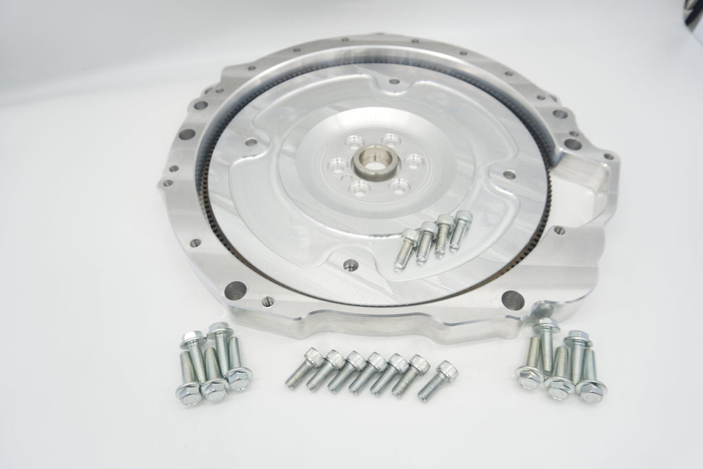 Front view of LS to Jaguar 8HP adapter plate with integrated dust shield and billet flex plate